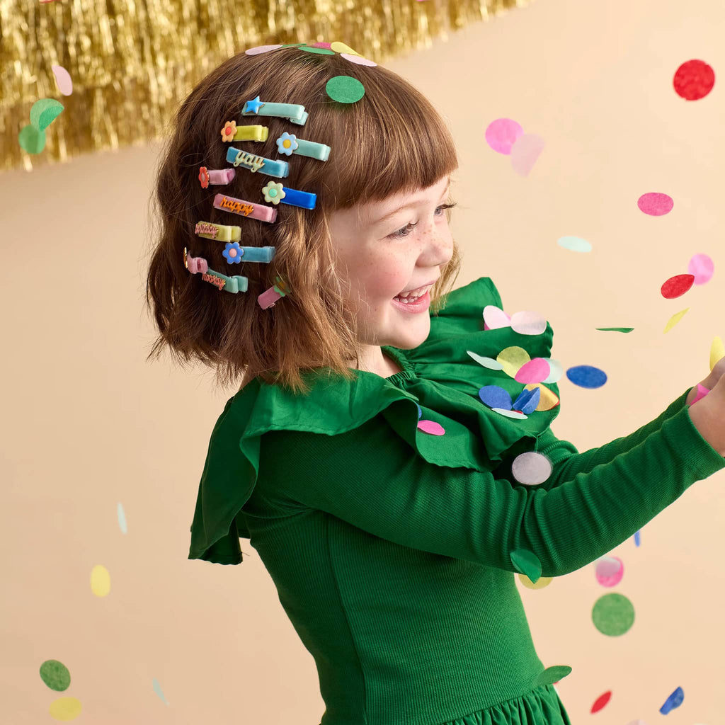 Meri Meri Enamel Daisy Hair Clips with velvet ribbon, in child's hair.