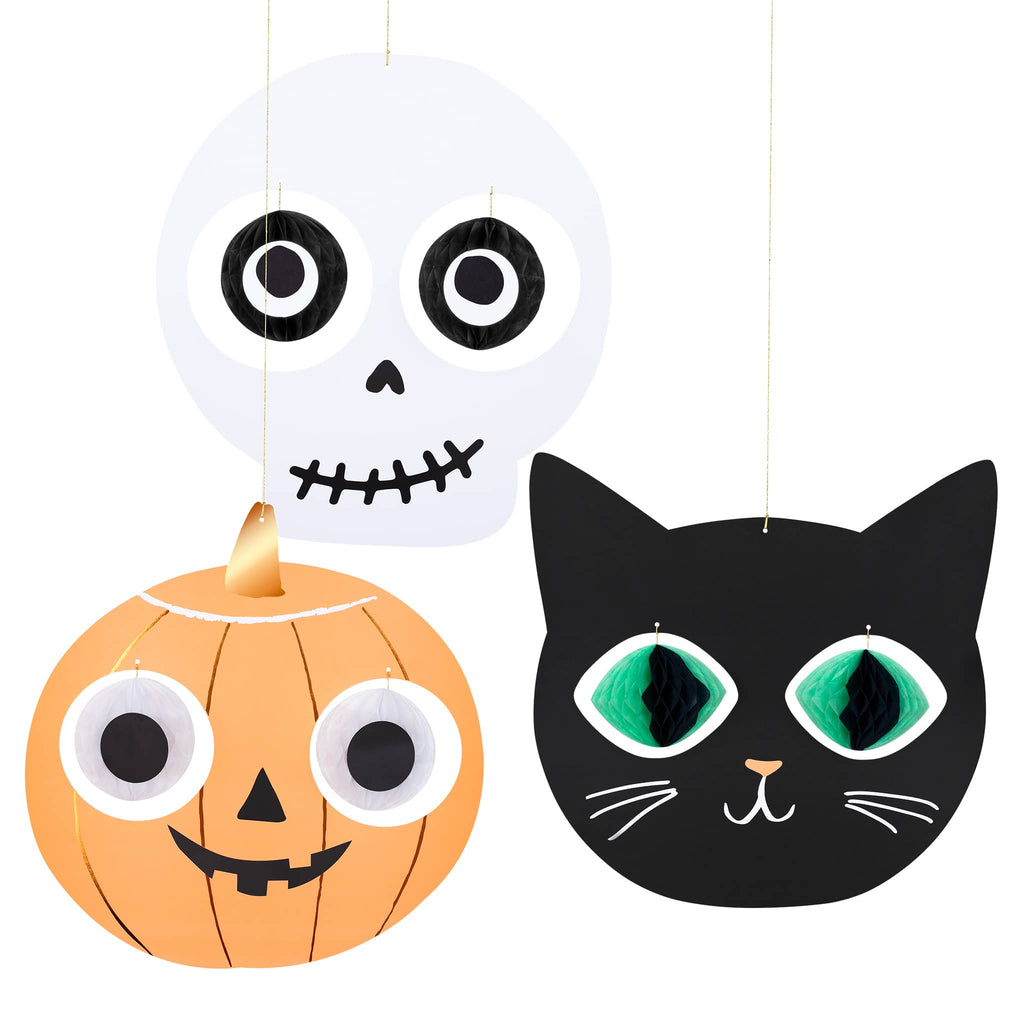 Halloween-themed decorations including a skull, pumpkin, and black cat head on a white background.