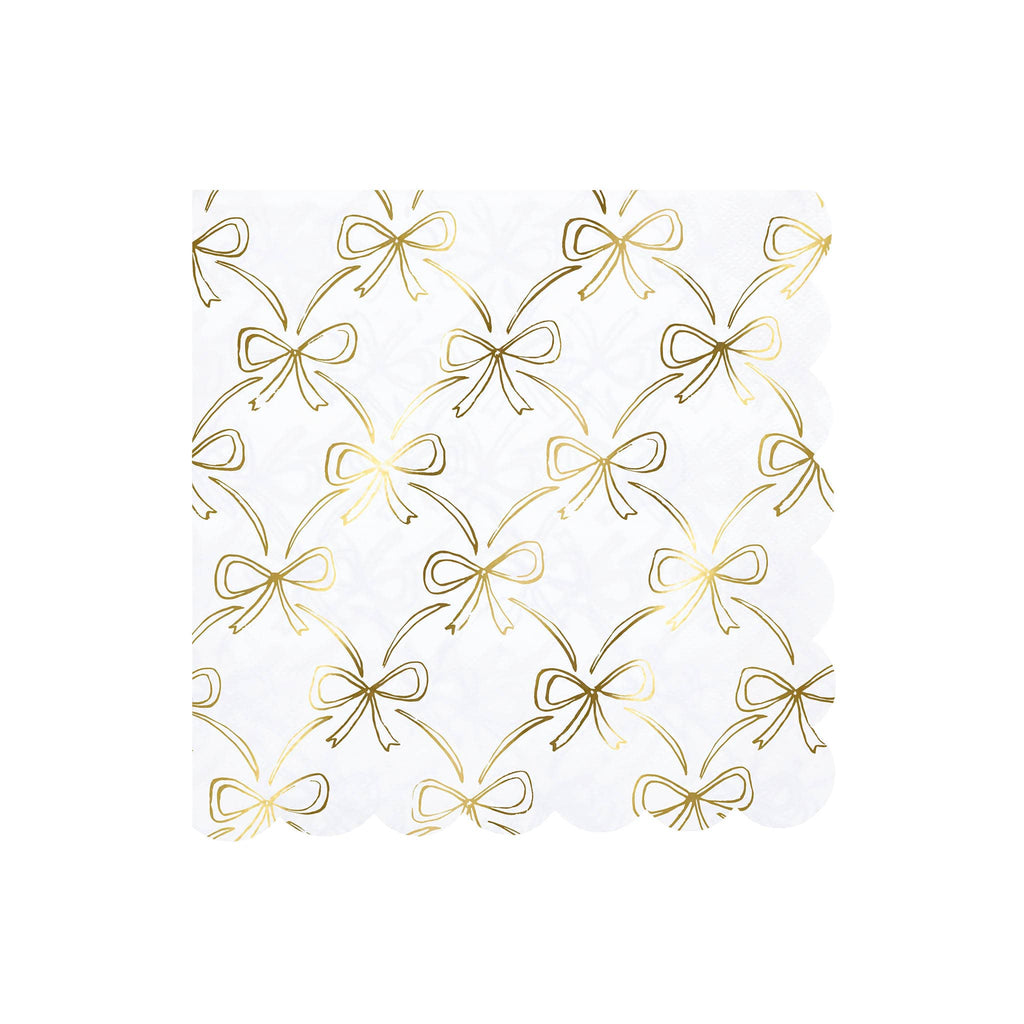 White paper napkins with gold bow pattern on a white background.