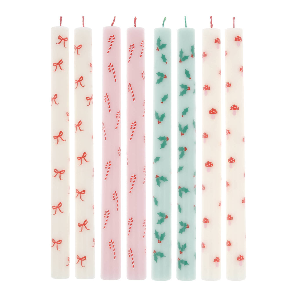 Set of 8 patterned candles on a white background.