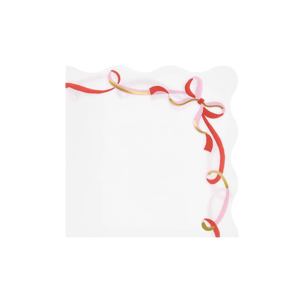 White paper napkin with red and gold decorative ribbons on a white background.