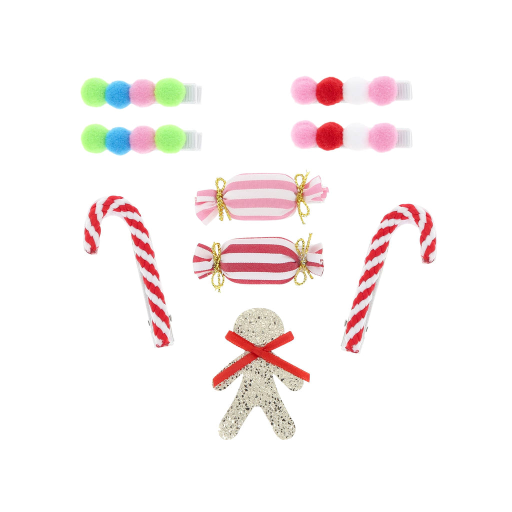 Set of Christmas-themed hair accessories including candy canes, gingerbread man, and striped candies on a white background.