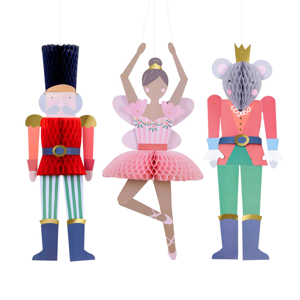 Decorative ornaments inspired by characters from 'The Nutcracker' on a white background.