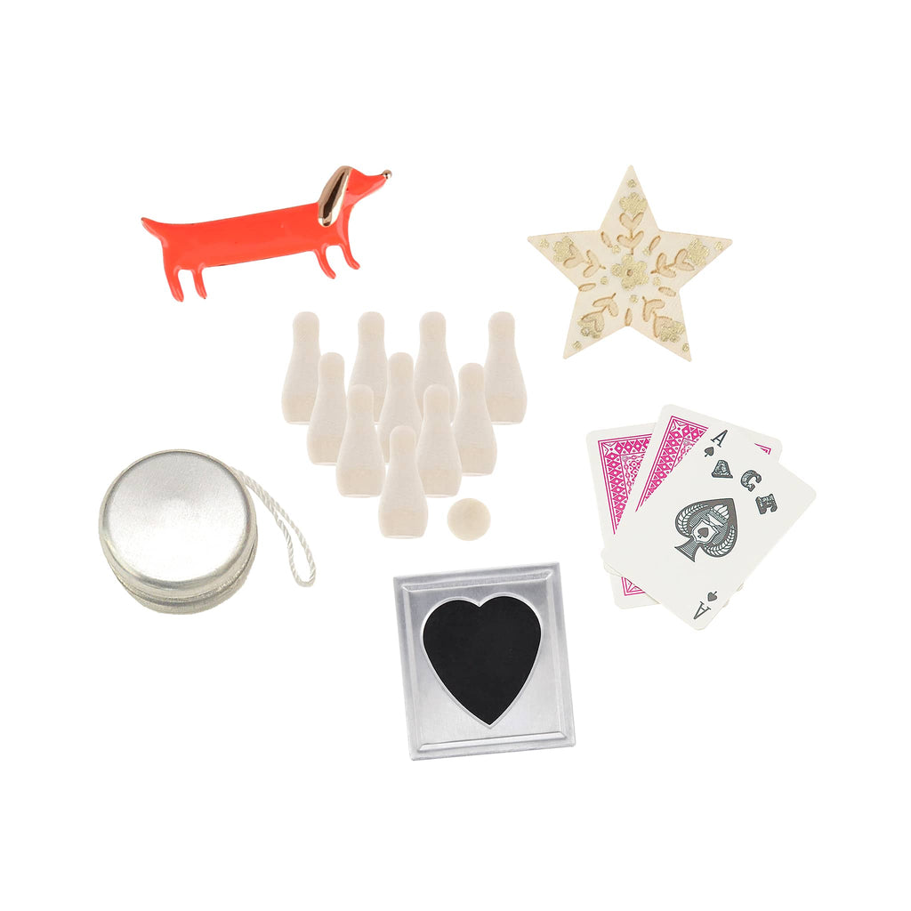 Collection of small items including a mirror, playing cards, and decorative objects on a white background.