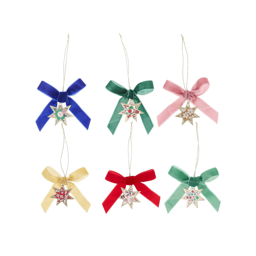 Set of colorful bow-shaped Christmas ornaments with star decorations on a white background.