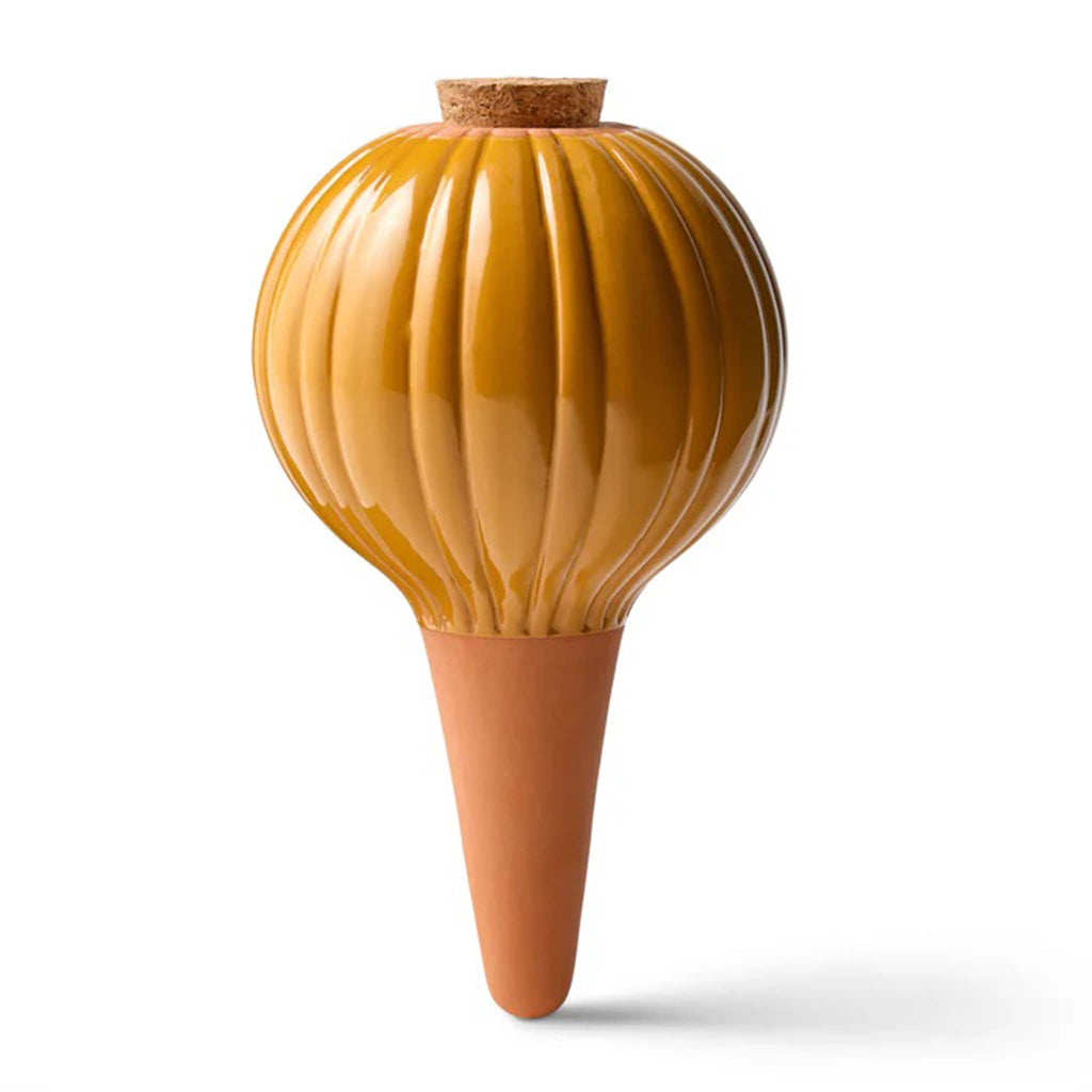 Yellow and terracotta-colored watering bulb with a textured design on a white background.