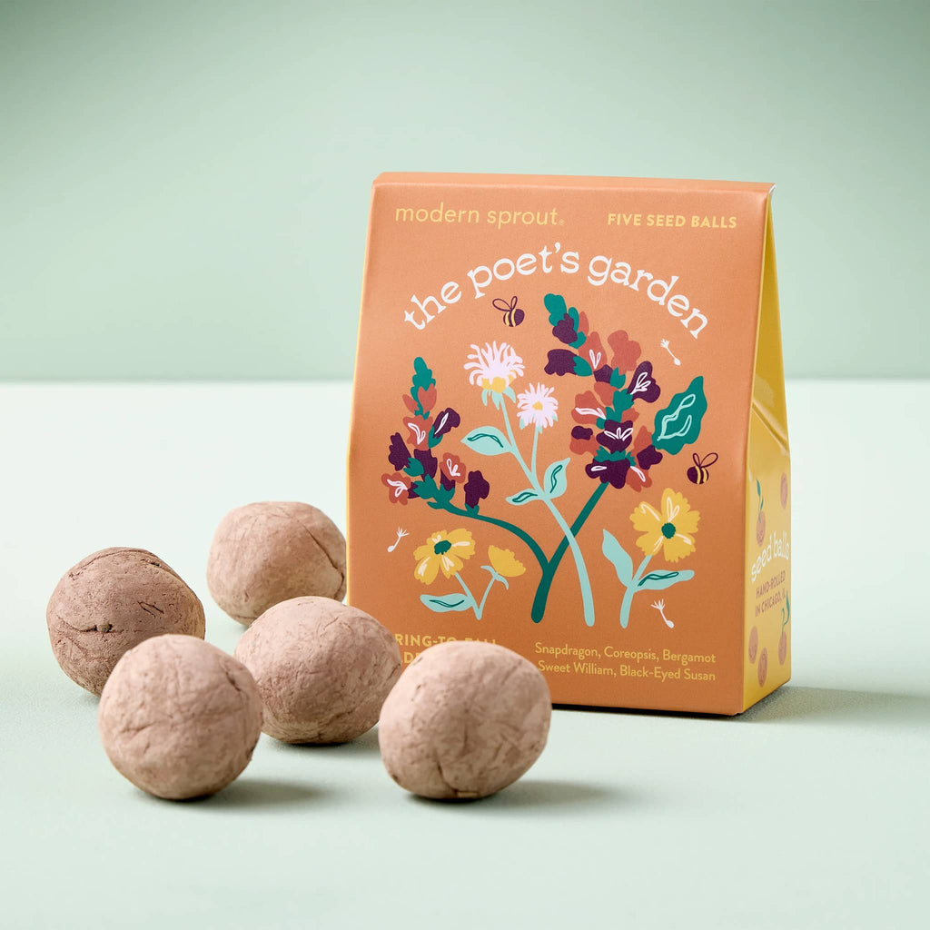Five seed balls in front of a 'the poet's garden' packaging on a light green background.
