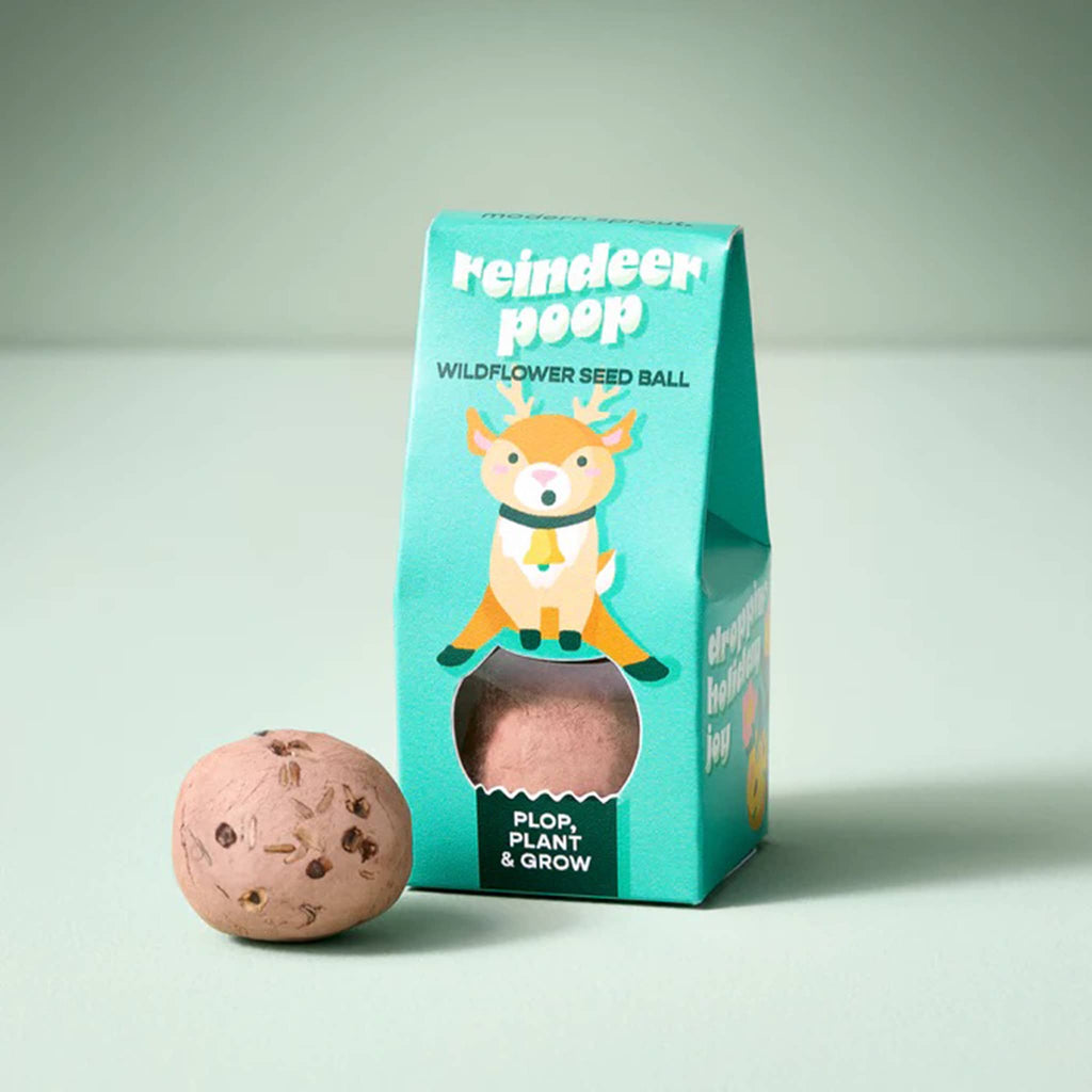 Reindeer poop wildflower seed ball with packaging on a light green background.