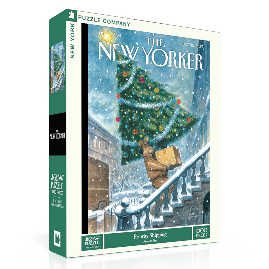 Jigsaw puzzle box featuring a New Yorker illustration of a delivery person carrying a Christmas tree on a snowy street.