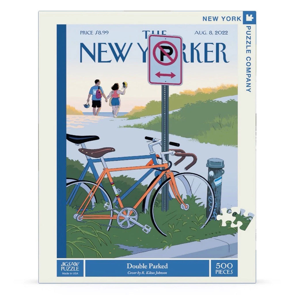 Front view of the box for New York Puzzle Company 500 piece Double Parked jigsaw with puzzle image of a couple holding hands lock and double park their bikes onto a signpost before heading down a path toward a beach.