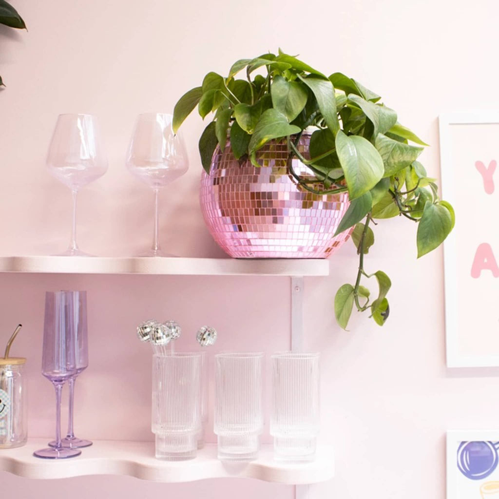 NPW pink mirrored disco ball ice bucket with plant.