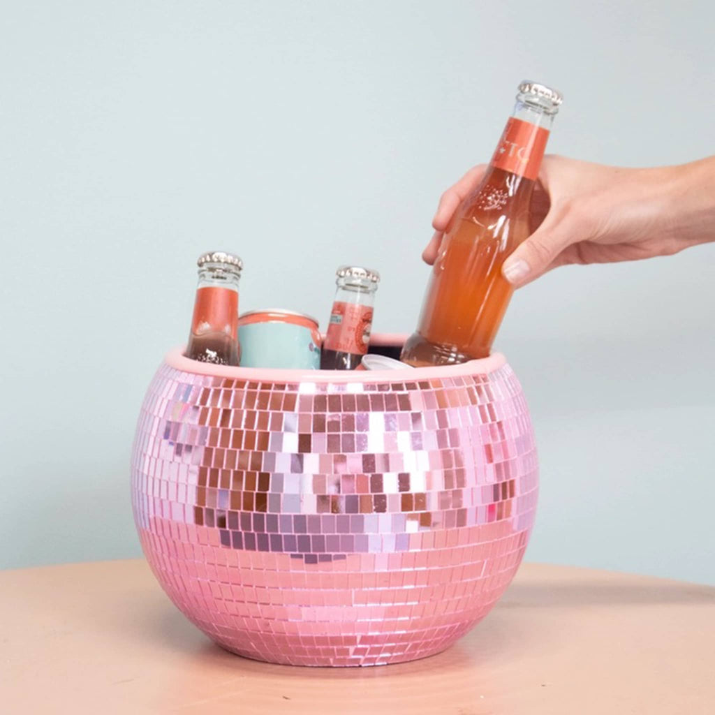 NPW pink mirrored disco ball ice bucket with bottles of soda.