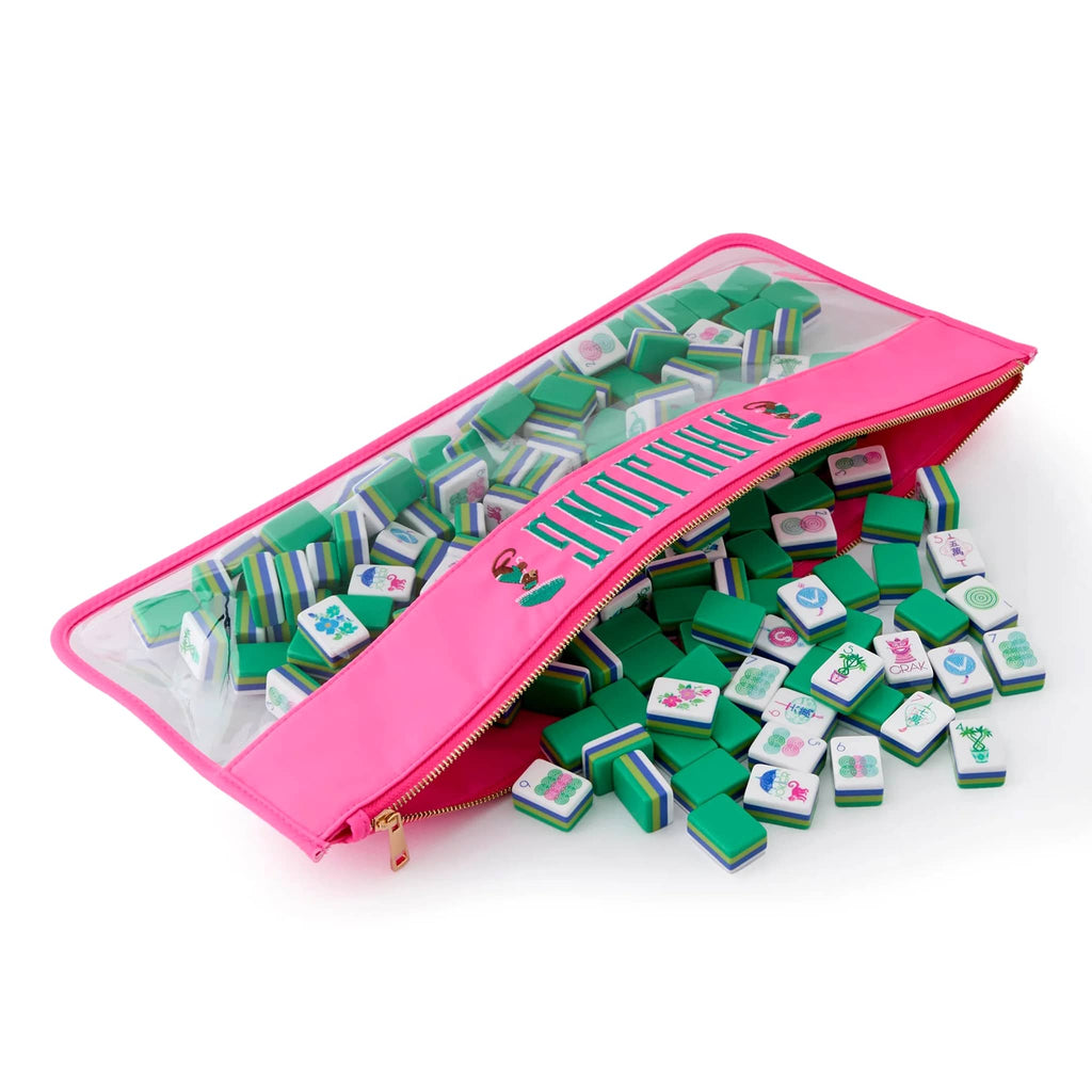 Pink zipper pouch filled with green and white game pieces on a white background.