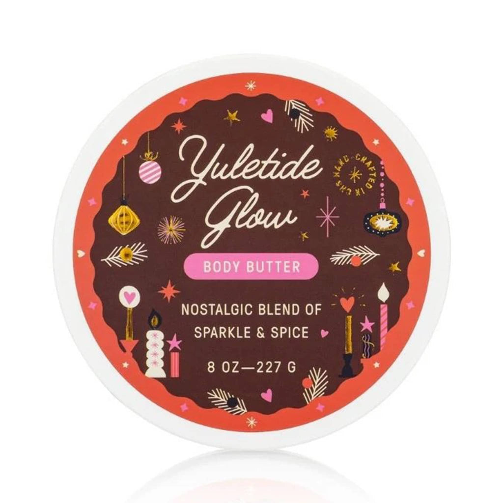 Yuletide Glow body butter container with festive design on a white background.