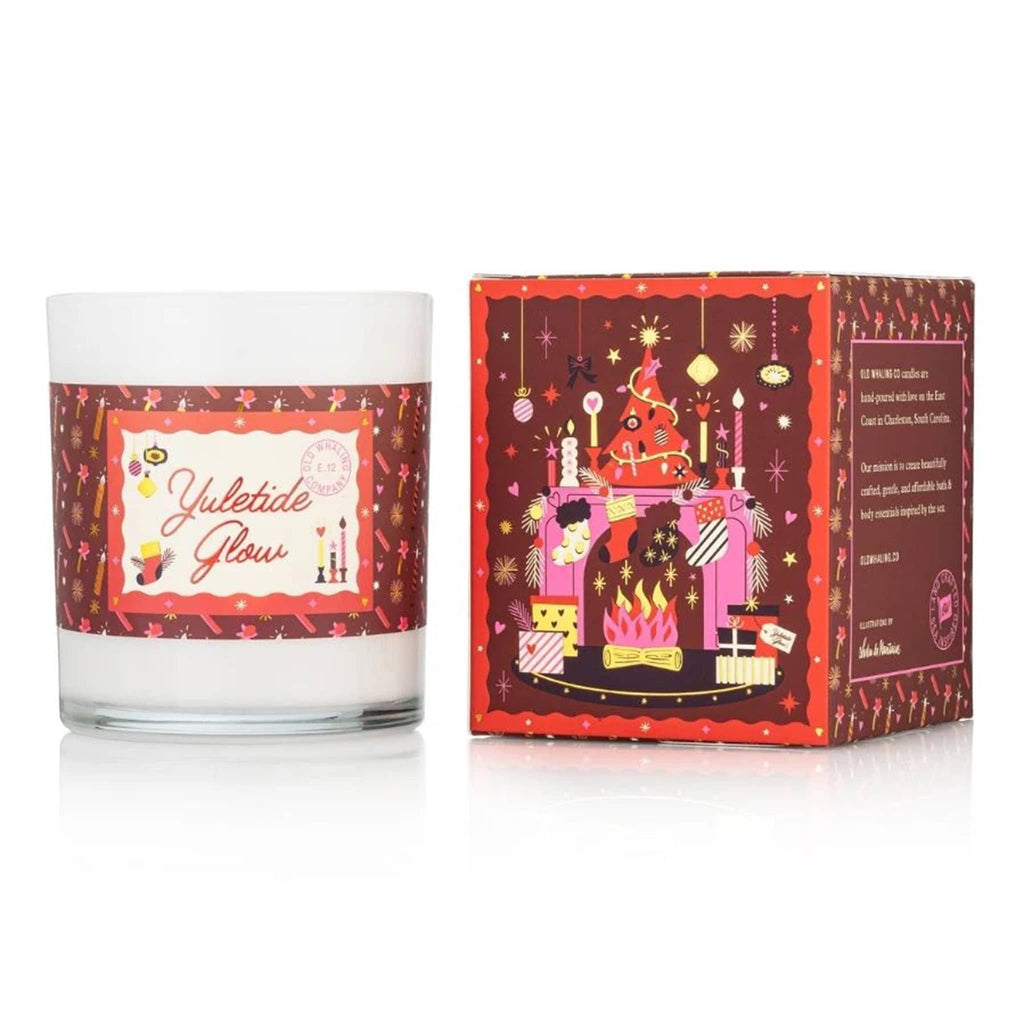 Candle with decorative label and matching box on a white background.