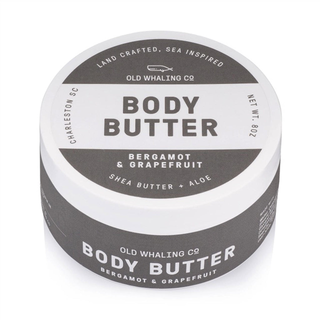 Old Whaling Company Bergamot and Grapefruit scented body butter with shea butter and aloe in white and gray ounce tub, side and top view.