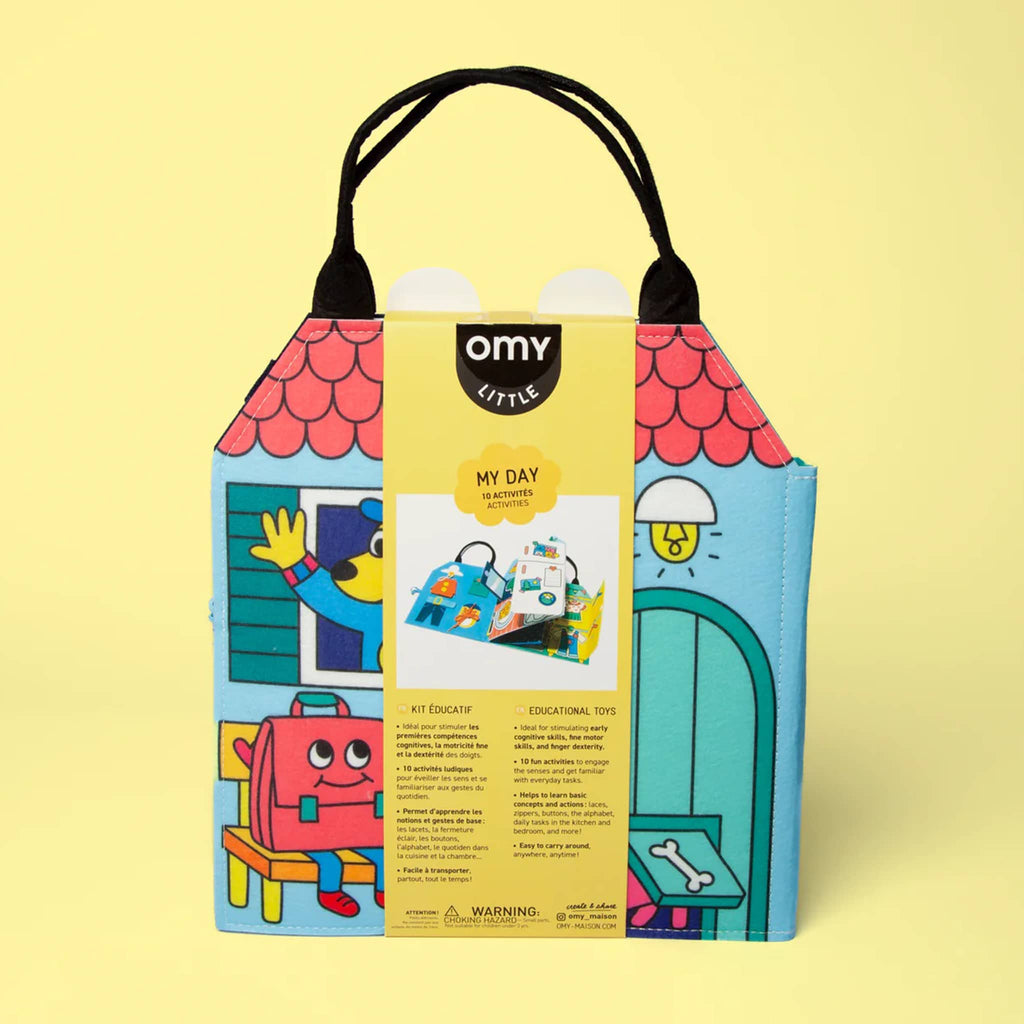 Colorful toy packaging with 'omy' branding on a yellow background.