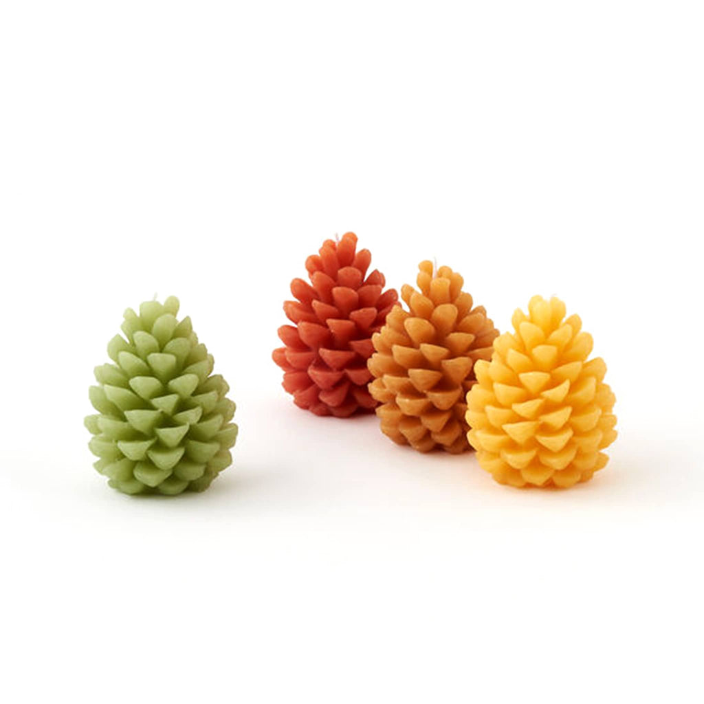 One Hundred 80 Degrees large pinecone shaped candles in green, dark orange, light orange and yellow.