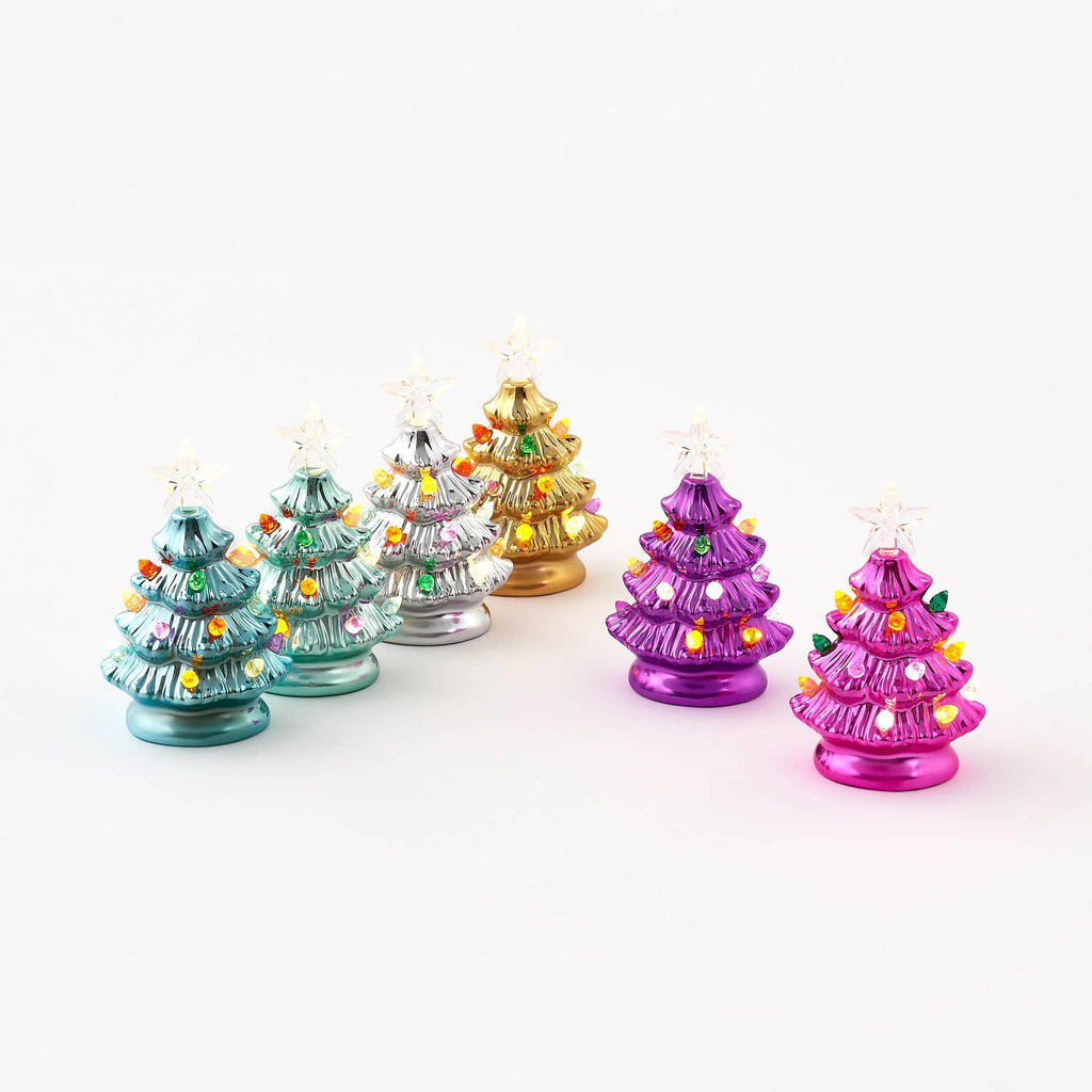 Colorful miniature ceramic Christmas trees with lights and star on top, on a white background.