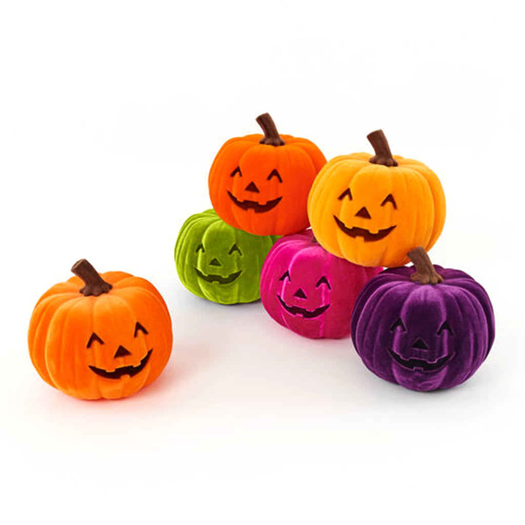 Colorful Halloween-themed flocked pumpkins with smiling faces on a white background.