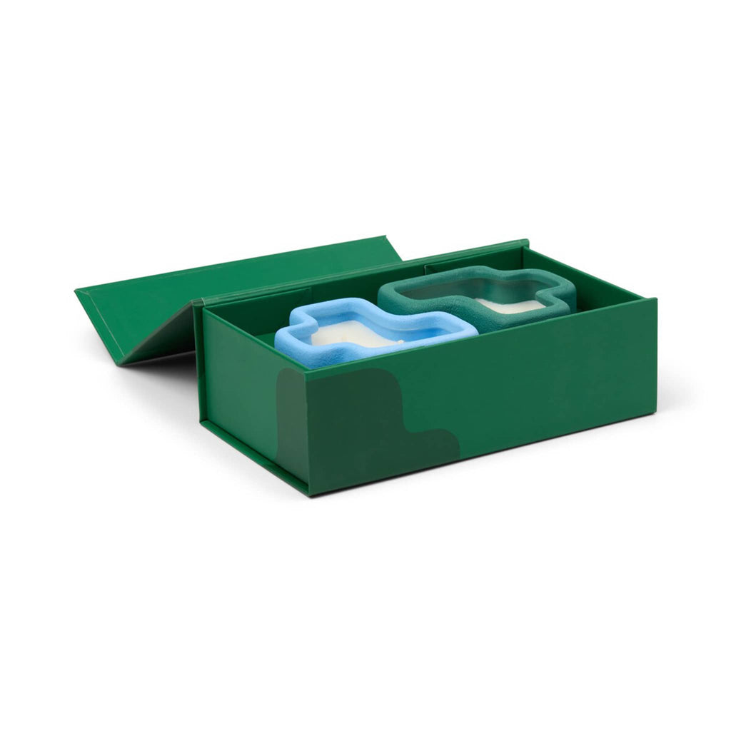Green box with a blue and white candles inside, on a white background.