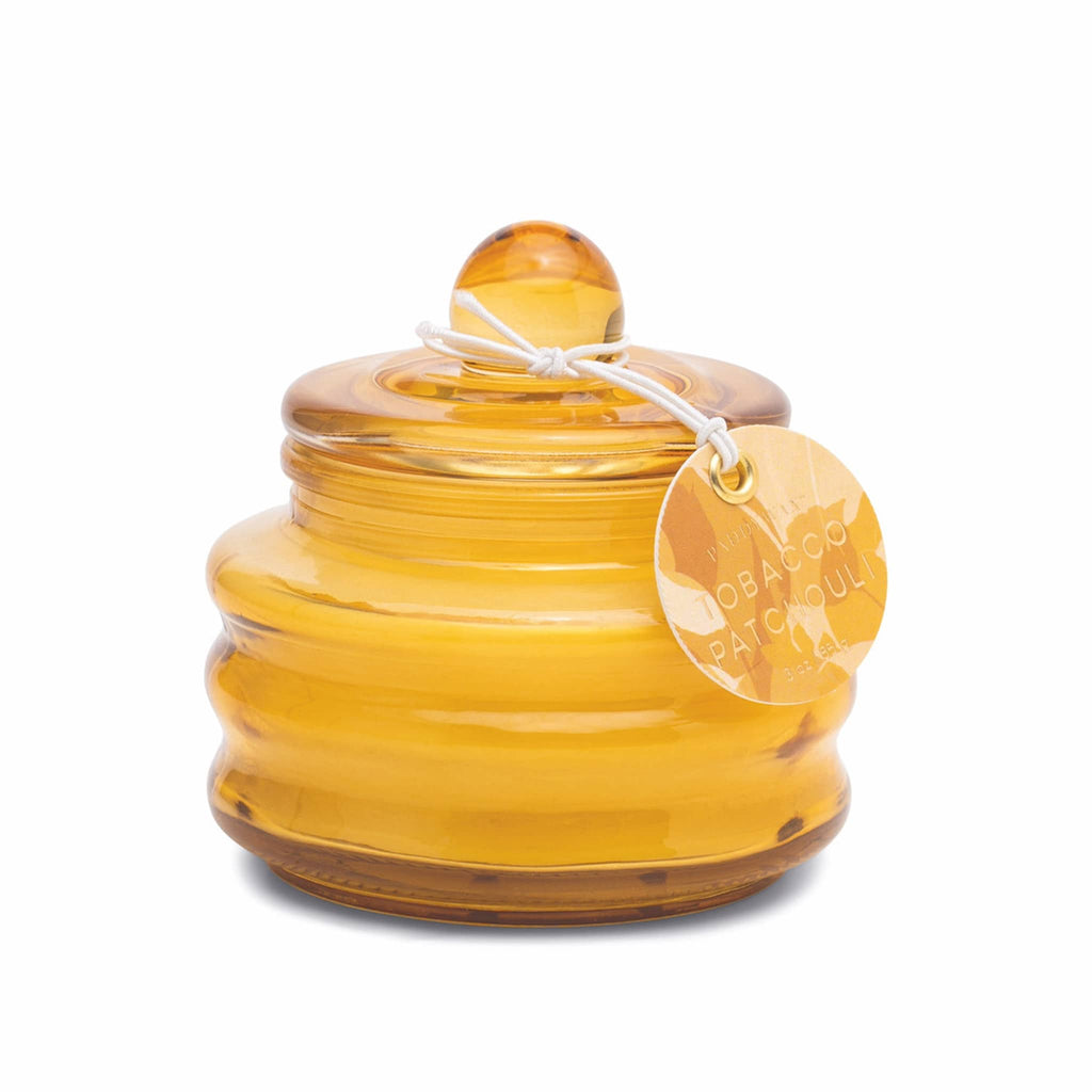 Paddywax Beam Tobacco + Patchouli scented soy wax candle in ochre yellow glass vessel with lid.