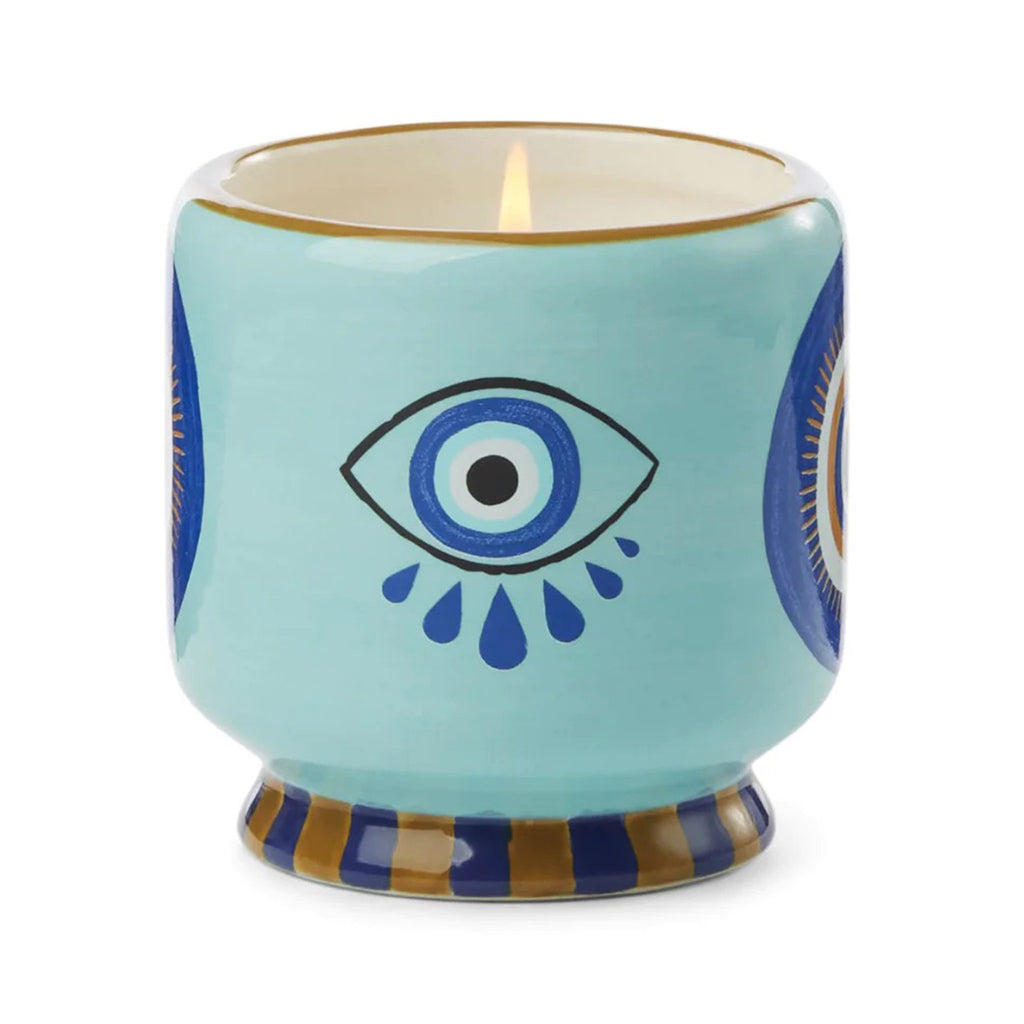 Paddywax A Dopo 8 ounce Incense and Smoke scented candle in a ceramic vessel hand painted with an eye design with teardrops.