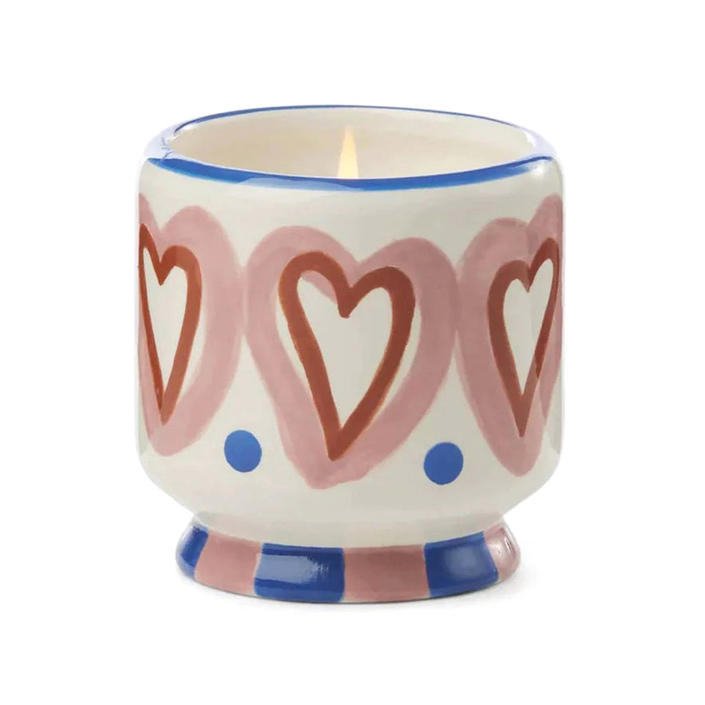 Paddywax A Dopo 8 ounce Rosewood Vanilla scented candle in a ceramic vessel hand painted with a heart design.