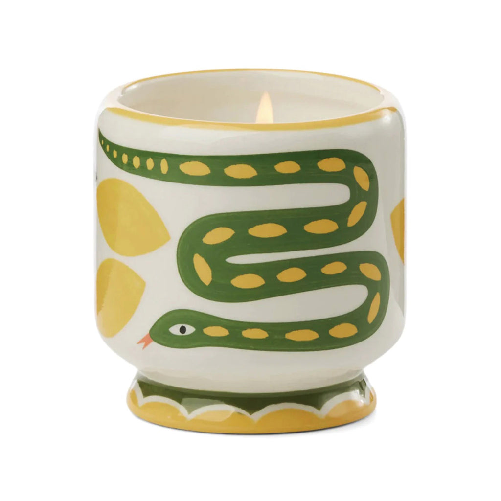 Paddywax A Dopo 8 ounce Wild Lemongrass scented candle in a ceramic vessel hand painted with a snake and lemon design.