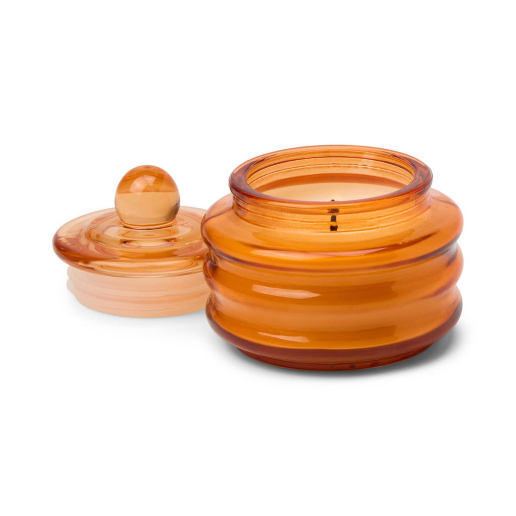 Paddywax Beam Pumpkin Spice scented candle in orange glass vessel with lid off, on a white background.