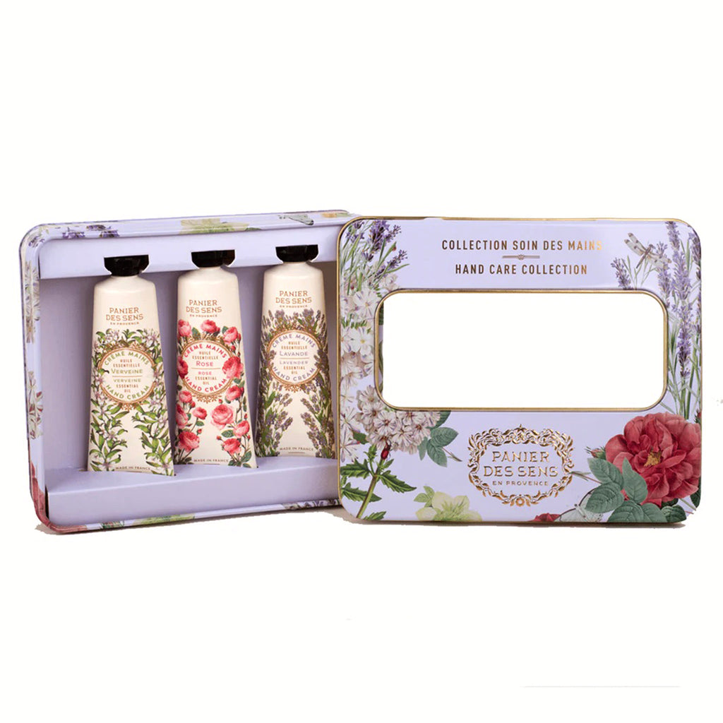 Panier Des Sens Hand Care Collection with Verbena, Rose and Lavender scented mini hand creams in a purple floral tin, lid off.