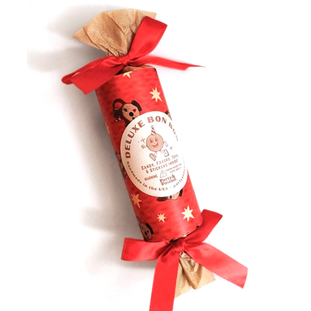 Christmas surprise bon bon favor with reindeer wrapping and bow on a white background.