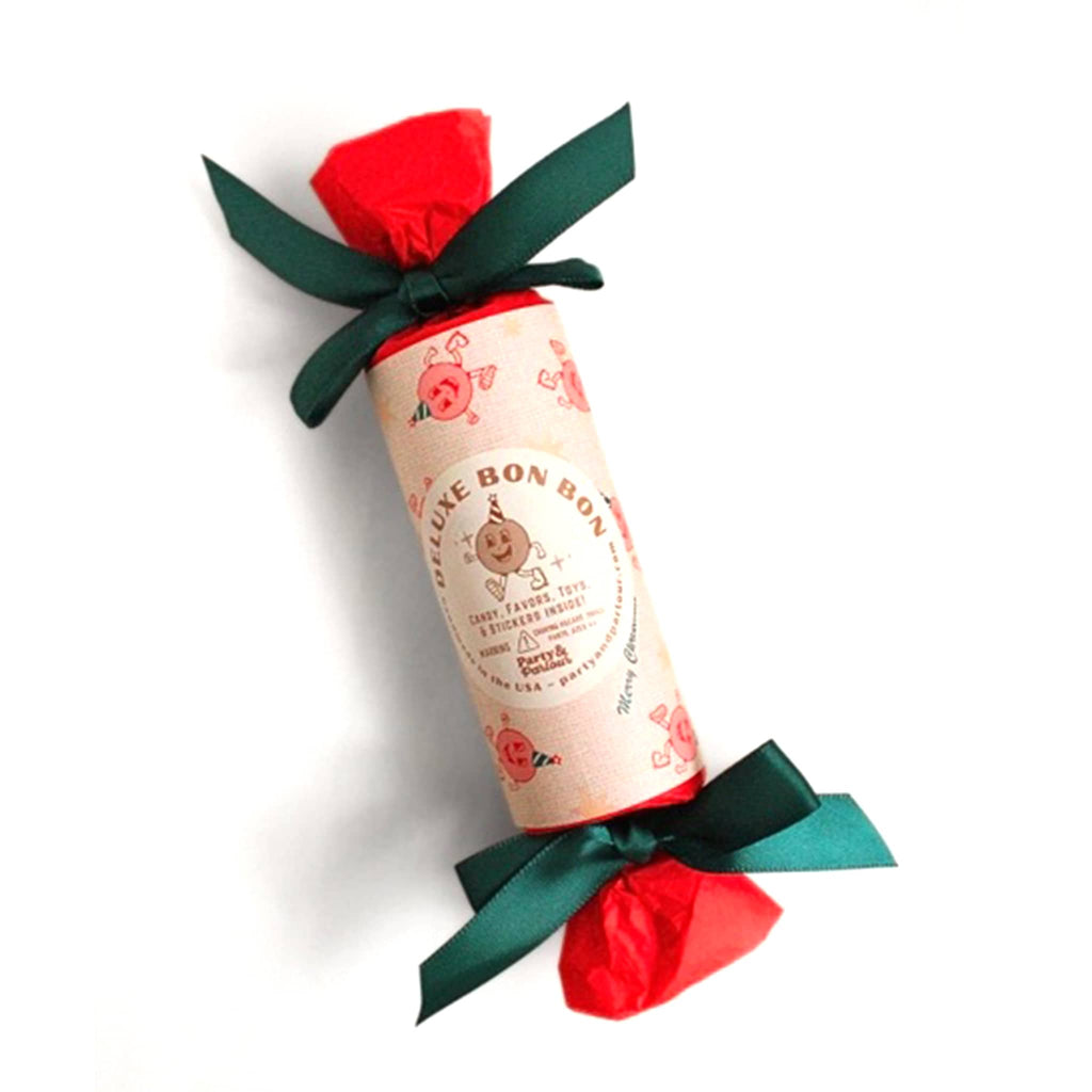 Christmas surprise bon bon favor with decorative wrapping and green bows on a white background.