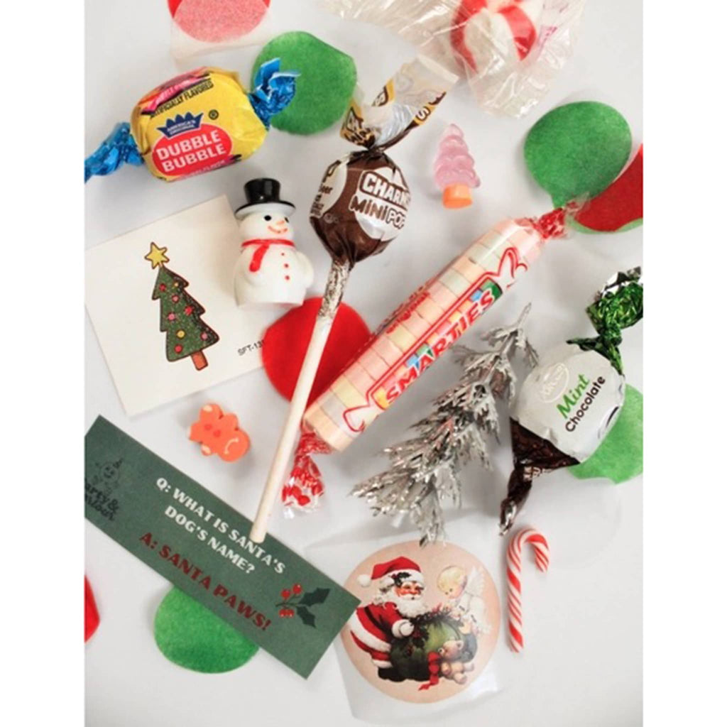 Assorted Christmas-themed candies and toys on a white background.