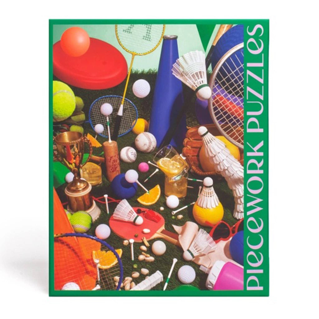 Piecework Puzzles 1000 Piece Field Day jigsaw puzzle in green box, back view with large puzzle image.