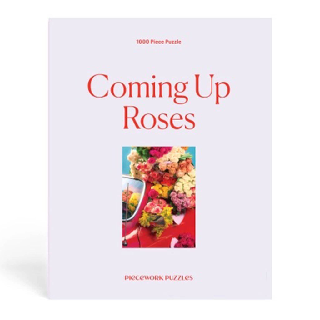 Piecework Puzzles 1000 piece Coming Up Roses jigsaw puzzle in box, front view.