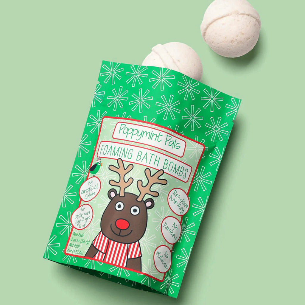 Packaging of Poppymint Pals foaming bath bombs with a reindeer illustration on a green background.