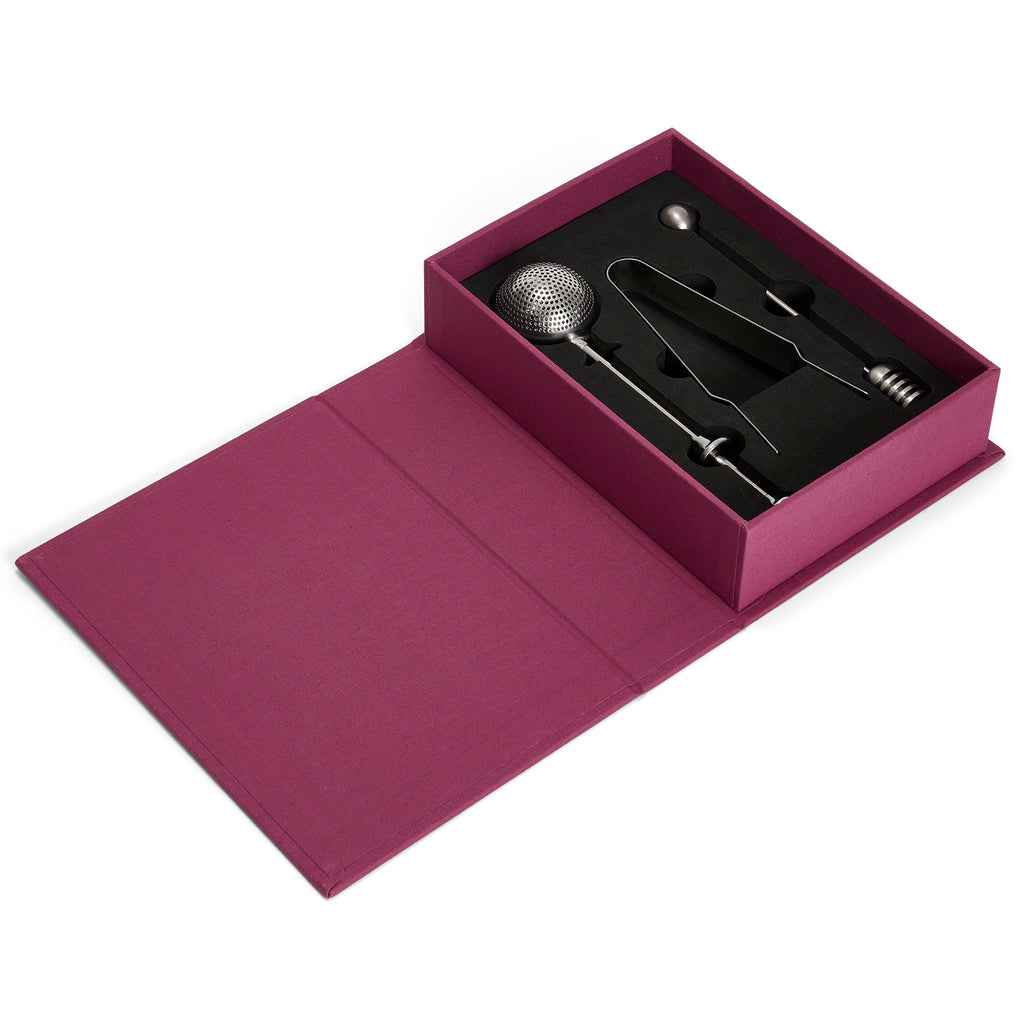 Printworks The Essentials Tea Tools for Tea Lovers, set of 3 stainless steel tools in red book box packaging, open showing tools nestled in black insert.