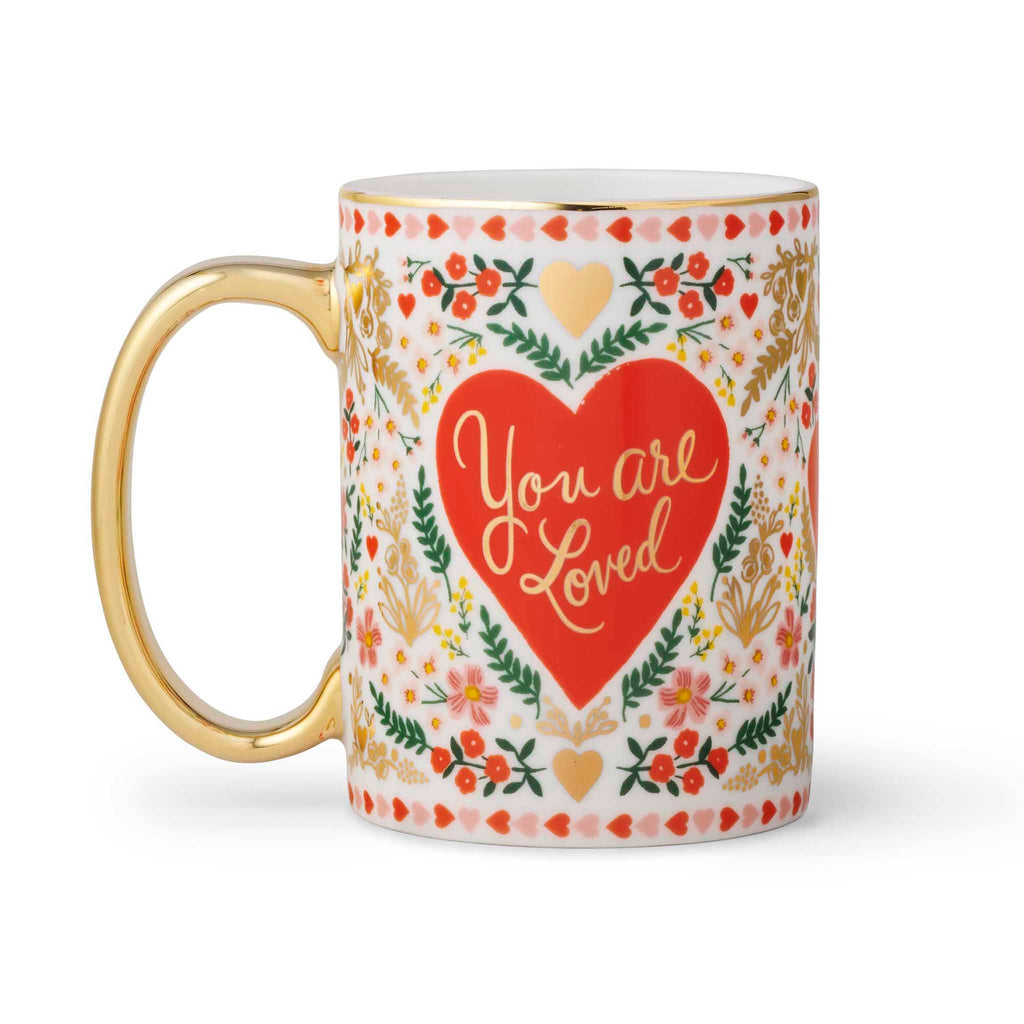 Rifle Paper Co. Juliet floral print porcelain mug with gold rim and handle, handle is on the left.