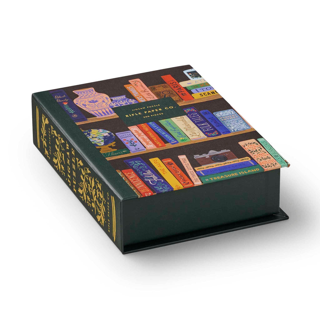 Rifle Paper Co. 500 Piece Bookshelf Jigsaw Puzzle in book box packaging, side view.