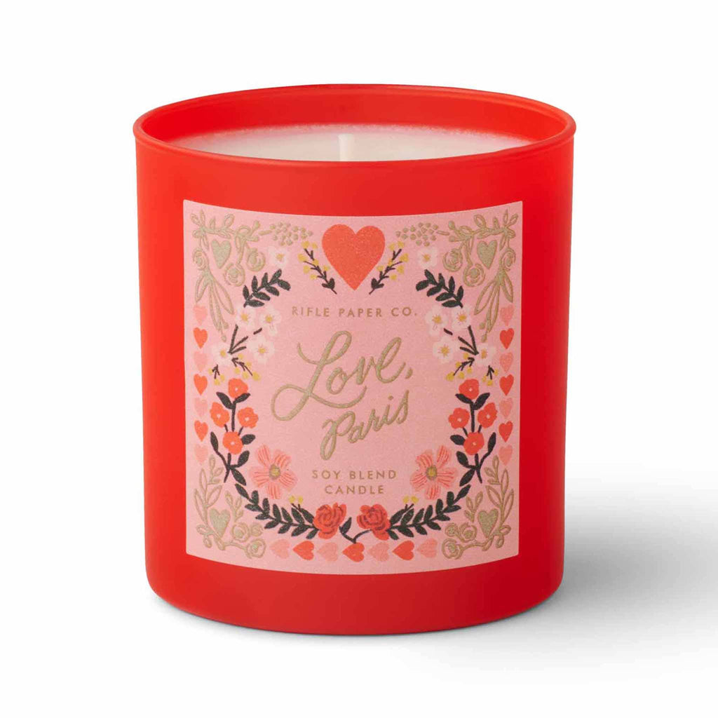 Rifle Paper Co. Love, Paris scented 9.5 ounce soy wax candle in red painted glass vessel, front view.