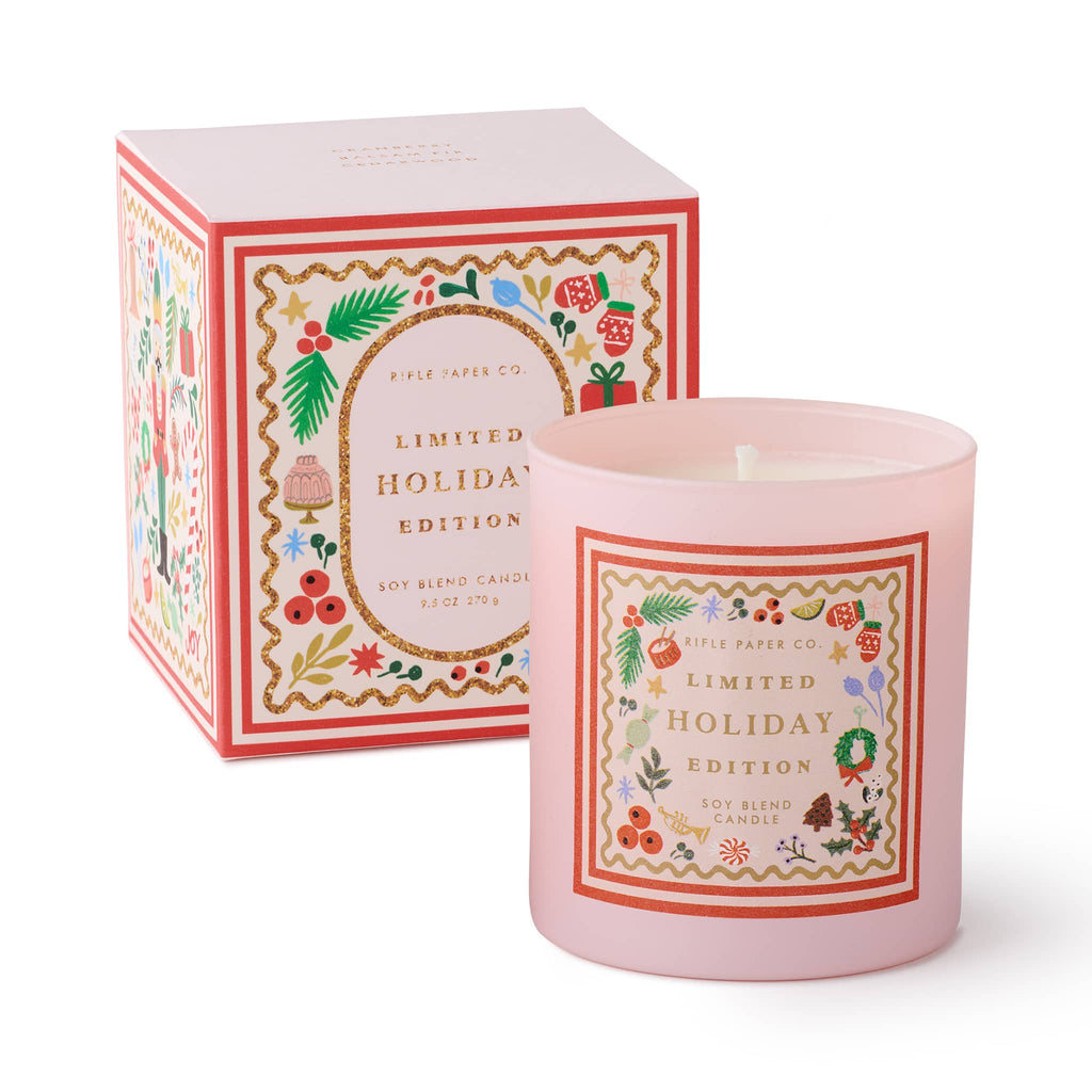Pink candle with decorative label and matching box on a white background.