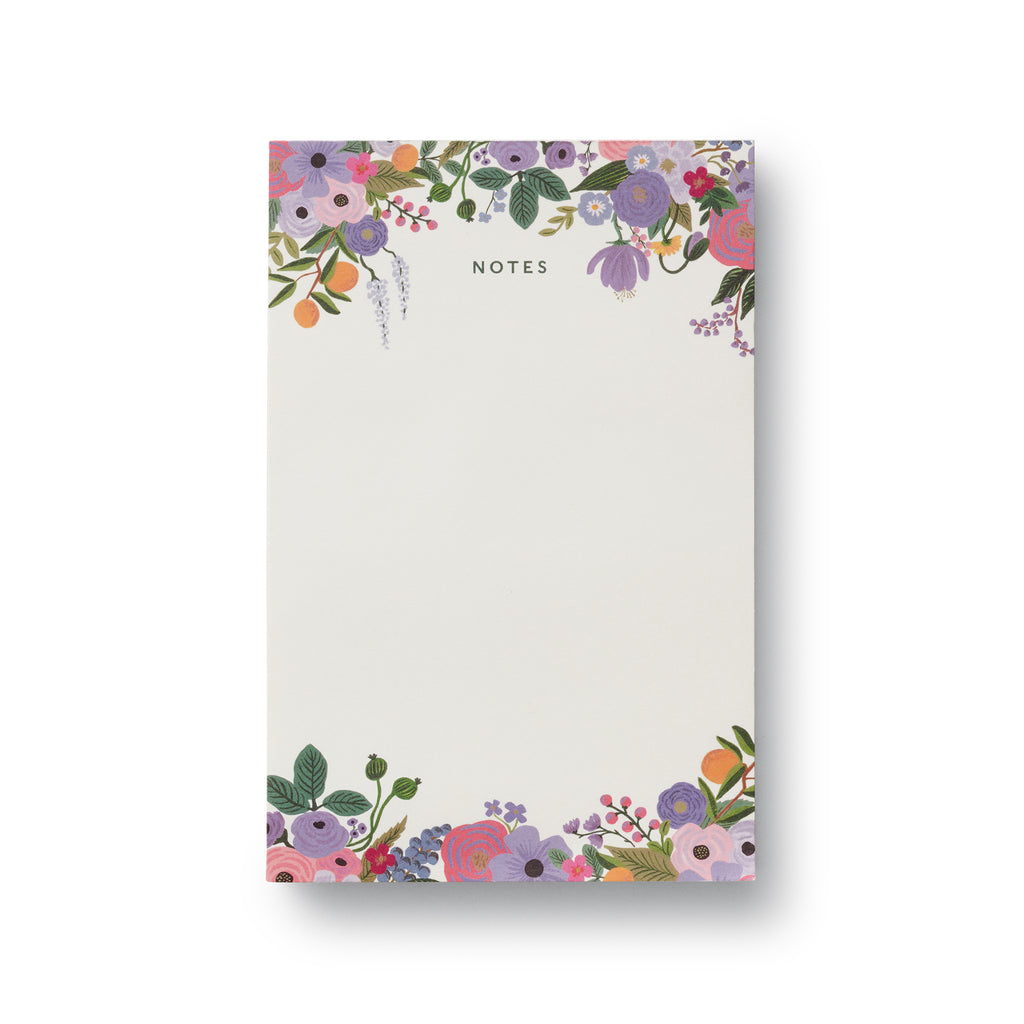 Rifle Paper Co. Violet Garden Party notepad with floral illustrations at the top and bottom of the unlined page.