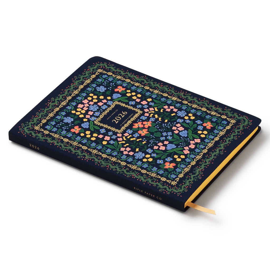Rifle Paper Co. Wildwood 2026 12-month floral embroidered book bound planner, spine and front cover, on white background.