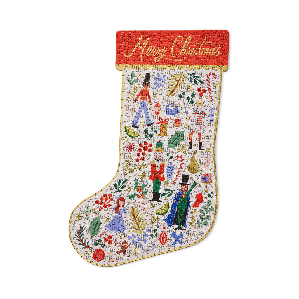 Christmas-themed stocking-shaped puzzle with nutcracker designs and 'Merry Christmas' on the cuff, on a white background.