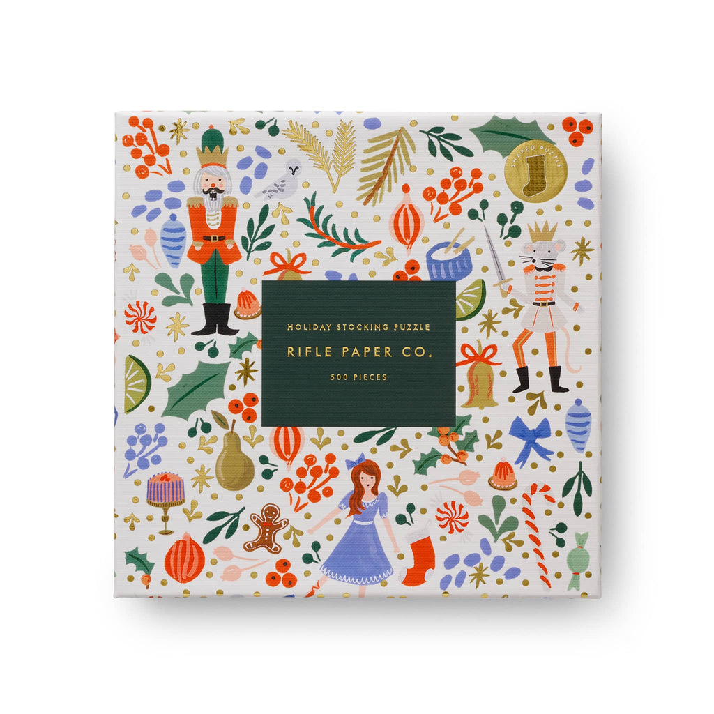 Rifle Paper Co. holiday stocking puzzle packaging with colorful illustrations on a white background.
