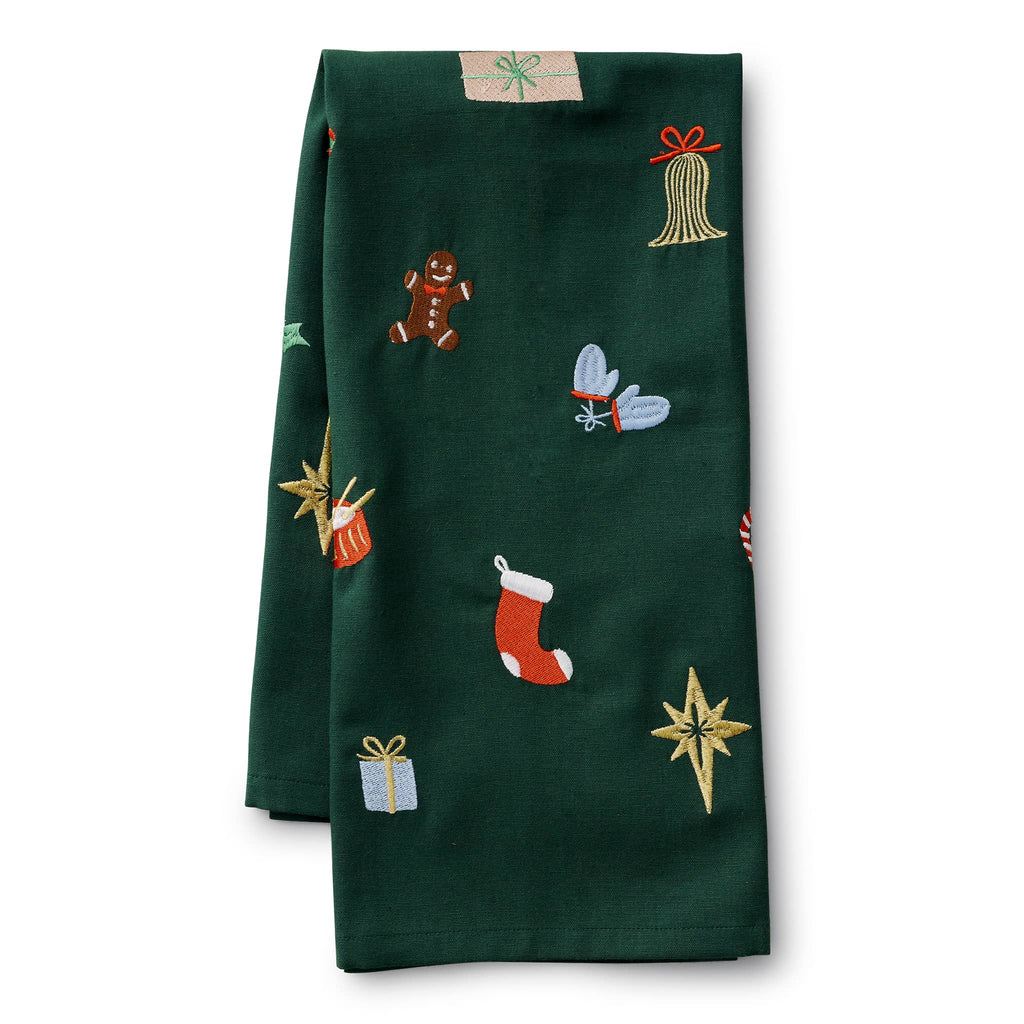 Dark green tea towel with embroidered Christmas-themed patterns, folded in half, on a white background.