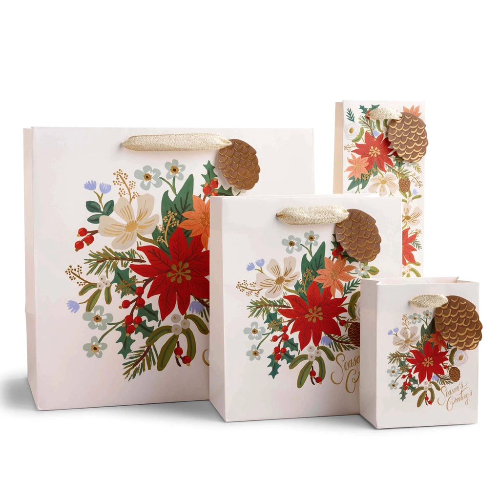 Rifle Paper Co. Holiday Bouquet Christmas Gift Bags, in 4 sizes. All are cream colored with poinsettia floral design with pinecone "to" and  "from" tag, "Season's Greetings" in gold script lettering and ivory cotton ribbon handles.