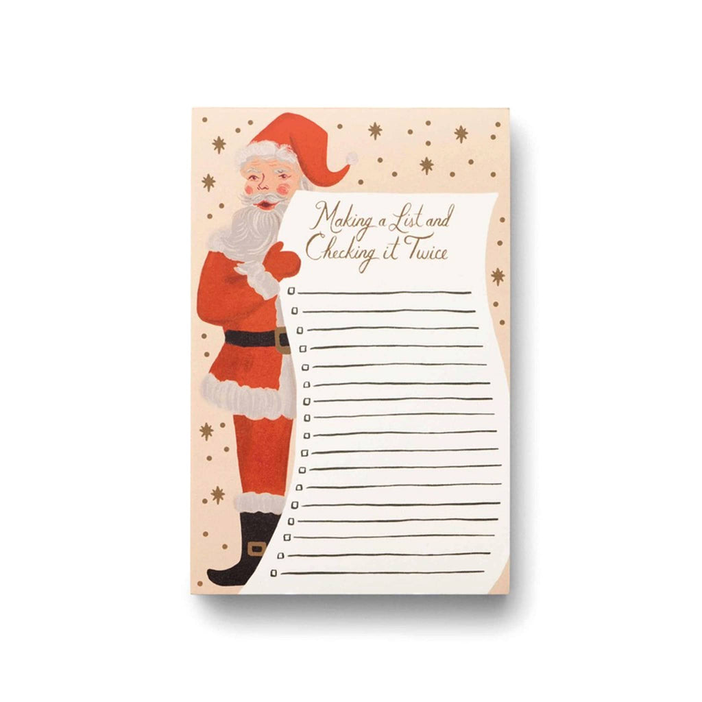 Rifle Paper Co. Santa's List Christmas Holiday Notepad with an illustration of Santa holding a list with lines and check boxes that says "making a list and checking it twice" at the top on a pale pink backdrop with gold stars.