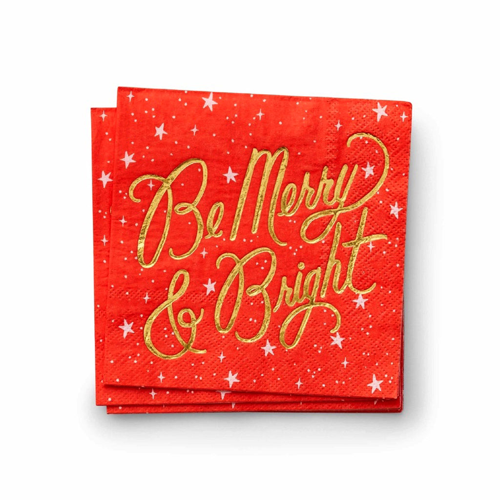 Rifle Paper Co. Holiday red paper party napkins with "be merry & bright" in gold foil script lettering.